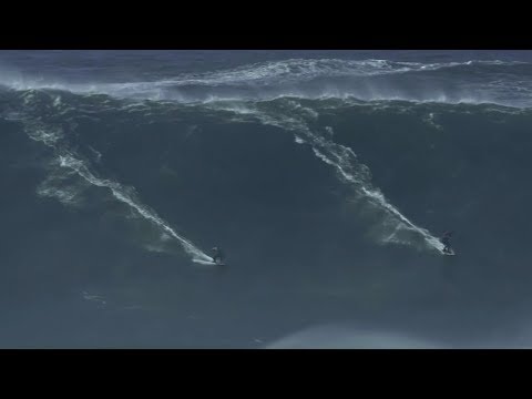 two surfers perform amazing double ride