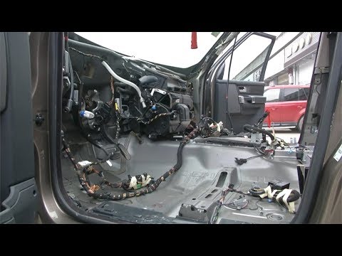 mechanics take apart a car to track down