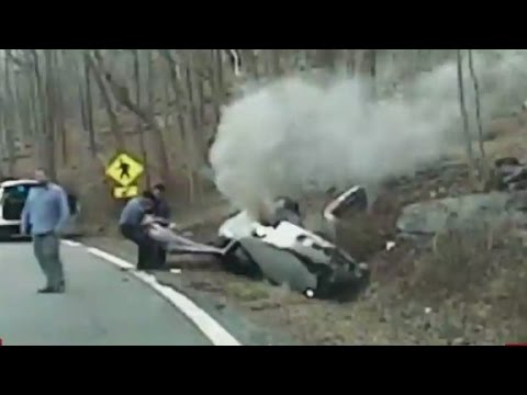 officers pull woman from burning car